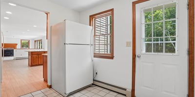 Bright kitchen area featuring convenient access to outdoor space and spacious layout, perfect for entertaining.
