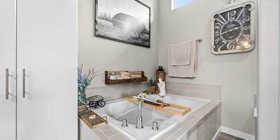 Primary Suite with attached 5 piece bath and walk in closet.
