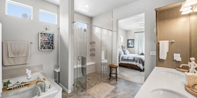 Primary Suite with attached 5 piece bath and walk in closet.