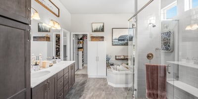 Primary Suite with attached 5 piece bath and walk in closet.