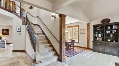 Spacious foyer features a sweeping staircase and provides access to an inviting dining area and living space.