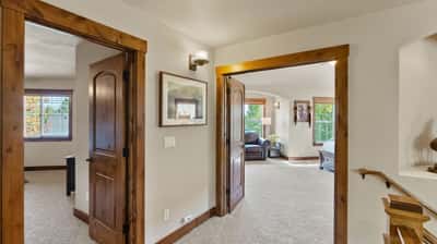 Spacious entryway leading to bright living areas, with abundant natural light and well-crafted wood accents.