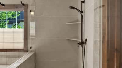 Modern bathroom featuring a spacious walk-in shower with contemporary fixtures and natural light.
