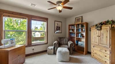 Bright and inviting multipurpose room with ample natural light and cozy reading nook.