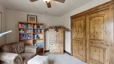Cozy reading nook features natural light, built-in shelving, and ample storage for books and personal items.