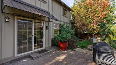 Discover a spacious outdoor patio perfect for relaxation and entertaining in a tranquil garden setting.