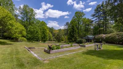 Expansive outdoor space featuring lush greenery and a tranquil garden area, perfect for relaxation and gatherings.