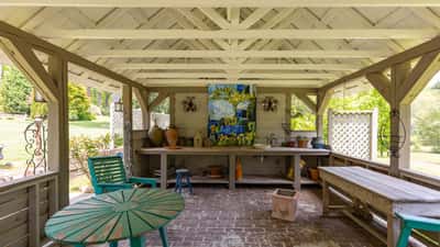 Spacious outdoor pavilion with artwork, ideal for gatherings and enjoying nature's beauty in a private setting.