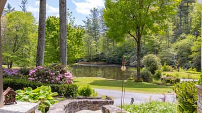 Breathtaking views of a tranquil pond surrounded by lush greenery, perfect for outdoor relaxation and enjoyment.