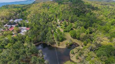 Discover a picturesque property featuring lush landscapes, a peaceful pond, and stunning mountain views.
