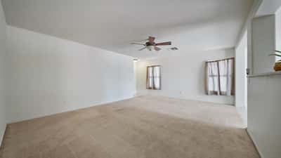 Expansive living room provides flexible furniture arrangements, abundant natural light, and easy access to the kitchen and dining area. A comfortable space designed for everyday enjoyment.