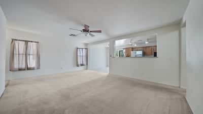 Open-concept living room connects beautifully to the kitchen and dining area, creating an ideal gathering space for family and guests. Bright interiors and neutral colors complement any decorating style.