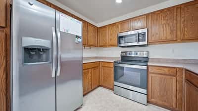 Kitchen features stainless steel appliances, extensive cabinetry, generous workspace, and a functional layout that makes meal preparation simple. A bright and efficient space designed for everyday living in Buckeye.