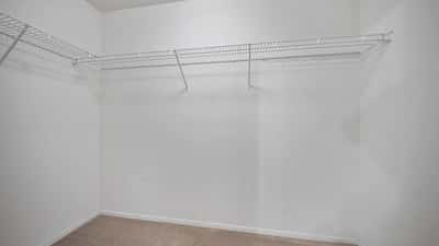 Expansive walk-in closet provides excellent storage with built-in shelving and generous hanging space. An ideal feature for keeping wardrobes organized and easily accessible.