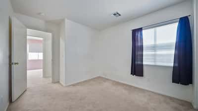 Spacious secondary bedroom offers neutral finishes, ample closet storage, and flexible living space suitable for guests, hobbies, or a quiet workspace.