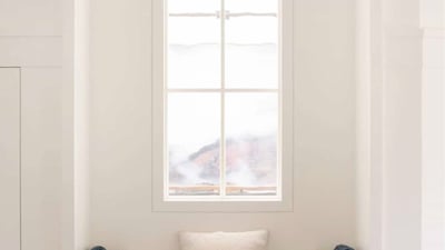 Charming window seat with plush cushions, perfect for cozy reading or enjoying natural light.