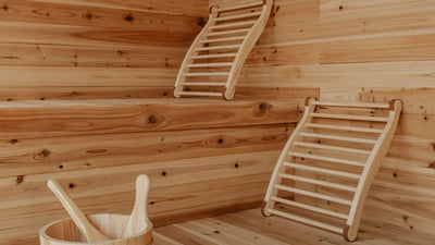 Experience this cozy sauna with warm wood tones and spacious seating for relaxation and rejuvenation.