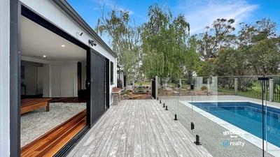 Modern home featuring open spaces, seamless indoor-outdoor flow, and a refreshing pool set amidst nature.