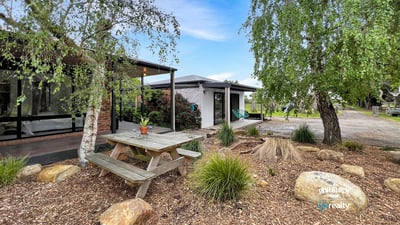 Discover a unique outdoor space featuring a picnic area surrounded by natural landscaping and modern amenities.