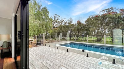 Spacious indoor-outdoor living with modern pool views, surrounded by lush greenery and serene landscapes.