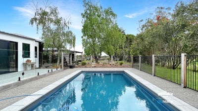 This property features a refreshing pool and landscaped yard, perfect for outdoor gatherings and relaxation.