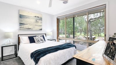 Bright bedroom with large windows offering scenic views and modern finishes for comfortable living.