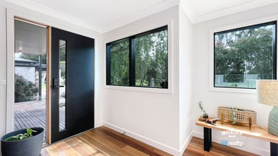 Bright entryway featuring large windows and natural light, welcoming you into a spacious home.