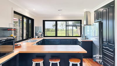 Modern kitchen featuring sleek cabinetry, expansive windows with scenic views, and a spacious island for entertaining.