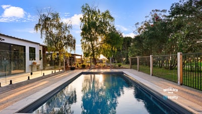 Discover this inviting outdoor space featuring a refreshing pool, surrounded by lush greenery and modern amenities.