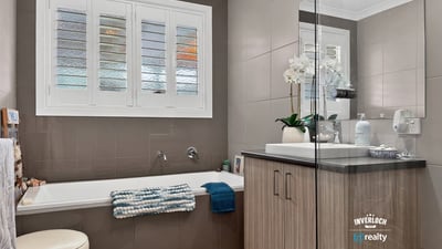 Modern bathroom featuring a spacious tub, ample natural light, and contemporary fixtures for everyday comfort.