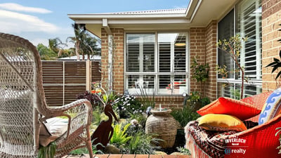 Discover a cozy outdoor space featuring lush landscaping, perfect for relaxation and outdoor gatherings.