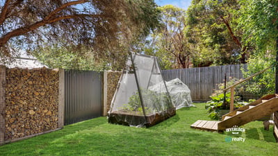 This spacious outdoor area features a productive garden and cozy relaxation spots surrounded by greenery.
