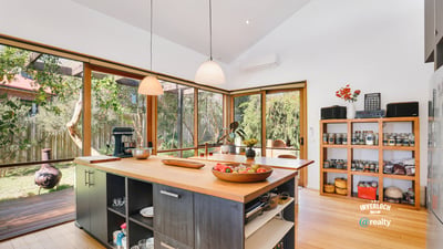 Bright and airy kitchen with expansive windows, featuring modern appliances and a spacious island for entertaining.