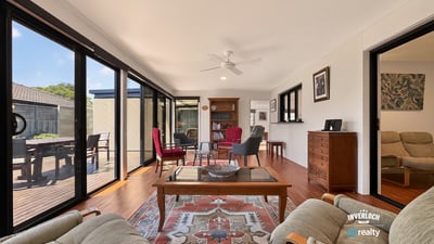 Bright and airy living space featuring large windows, comfortable seating, and a view of the outdoors.