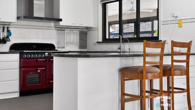Modern kitchen featuring sleek appliances, ample counter space, and a cozy breakfast bar for casual dining.