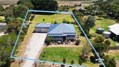 Spacious property featuring a large yard, dual garage, and expansive views in a tranquil rural setting.