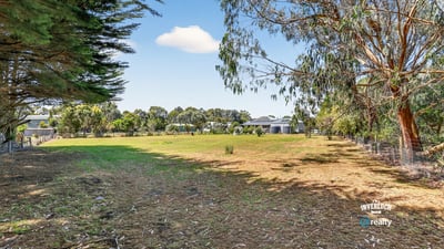 Spacious vacant lot with mature trees, offering limitless potential for your dream home or investment opportunity.