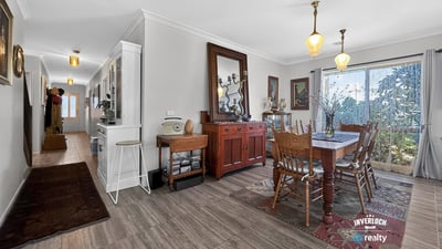 Spacious dining area featuring natural light and direct access to a beautifully landscaped outdoor space.