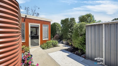 This property showcases a unique outdoor space with vibrant landscaping and modern design elements.
