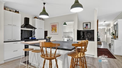 Modern kitchen featuring a spacious island, sleek cabinetry, and ample natural light flowing throughout the open layout.