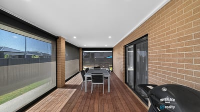 Spacious covered patio featuring outdoor dining and barbecue area, perfect for entertaining and enjoying the outdoors.