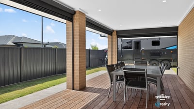 Spacious covered patio perfect for outdoor dining, featuring ample room for entertaining and relaxation.