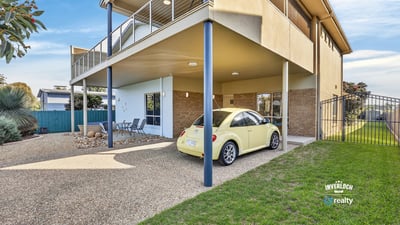 Spacious multi-level home featuring outdoor parking, a covered patio, and a lush backyard for relaxation.