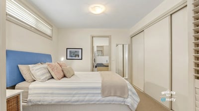 Bright and spacious bedroom featuring ample storage and an inviting atmosphere, perfect for relaxation.