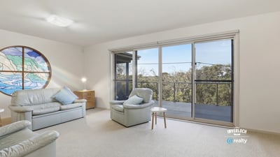 Spacious living area with panoramic views, ample natural light, and easy access to outdoor balcony space.