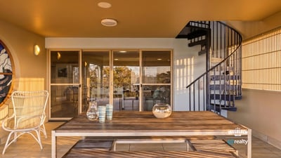 Spacious outdoor patio featuring a spiral staircase, perfect for entertaining and enjoying panoramic views.