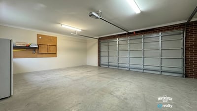 Spacious garage featuring ample storage options and abundant natural light, ideal for vehicles and projects.