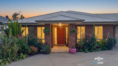 Welcoming home featuring vibrant landscaping and inviting entrance, perfect for enjoying the outdoors.