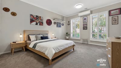 Spacious bedroom featuring large windows, contemporary decor, and ample storage in a tranquil setting.