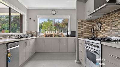 Bright and functional kitchen featuring modern appliances and a scenic view through large windows.
